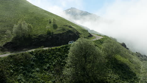 tskhratskaro pass with car driving during foggy day in samtskhe-javakheti, georgia