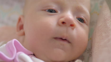 a closeup of a yawning baby girl face