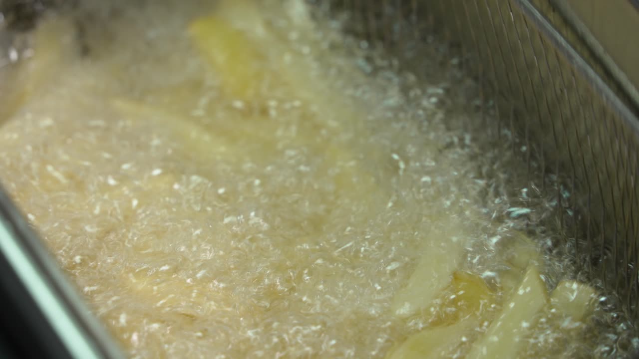 French Fries Being Fried in a Deep Fryer