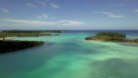 aerial orbit reveal of islands and shallow water. new caledonia