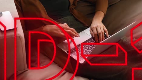 animation of red neon word covid-19 over caucasian woman using a laptop