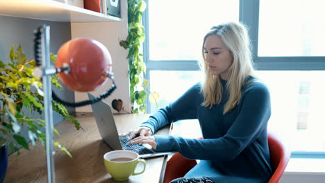 Woman-using-laptop-at-home-4k