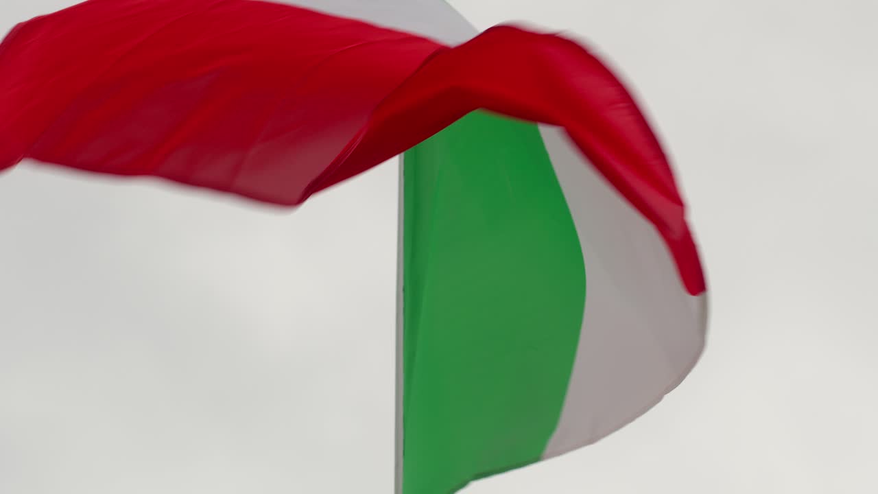 Macro view of vibrant Italian flag waving in soft wind in Sicily, Italy (Sicilia, Italia), with detail and motion