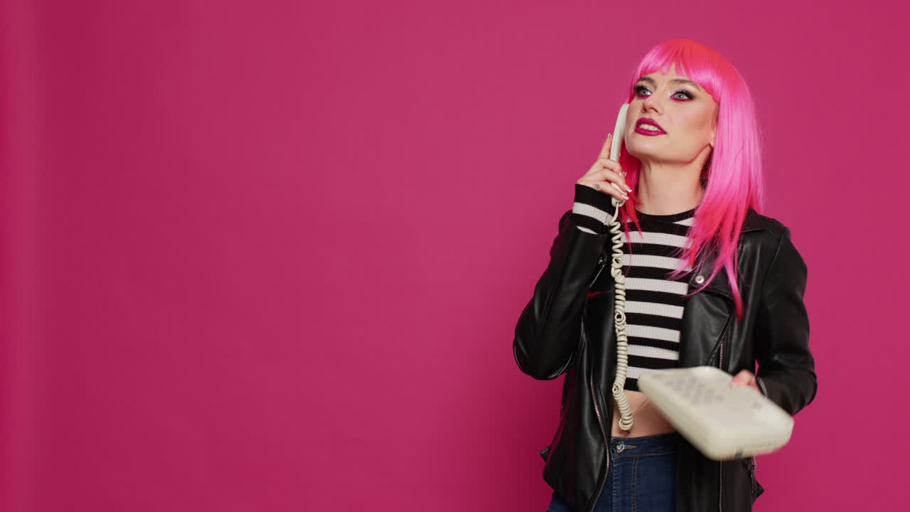 Young stylish person chatting on vintage telephone line