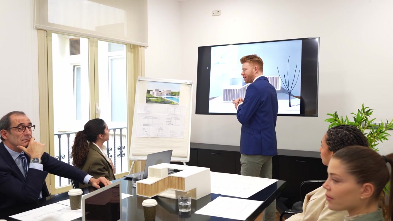Architect Presenting Building Design to Business Team in Conference Room