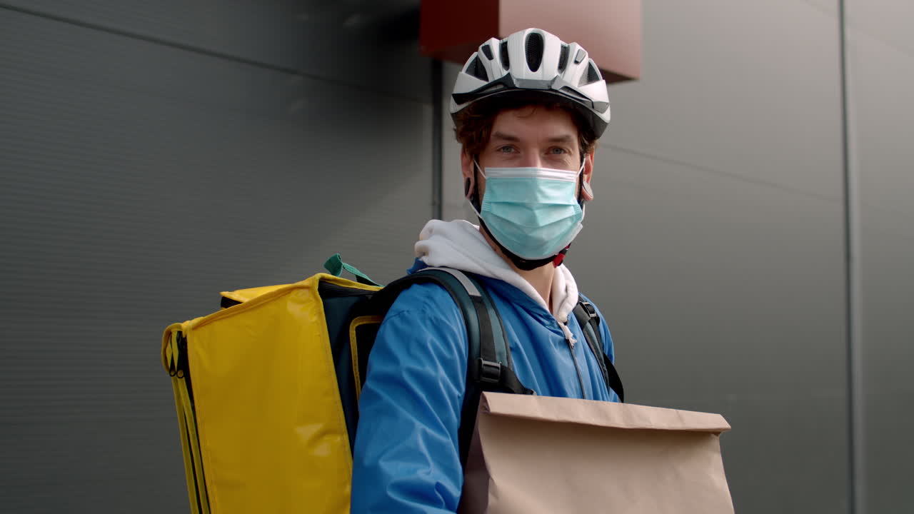 Delivery Courier with Face Mask and Bicycle Helmet