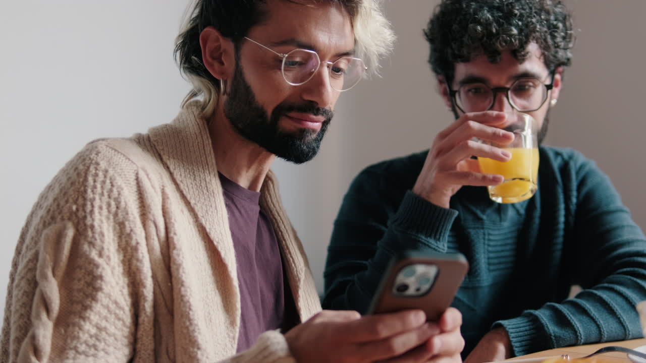 Gay Couple Enjoys Breakfast and Phone at Home