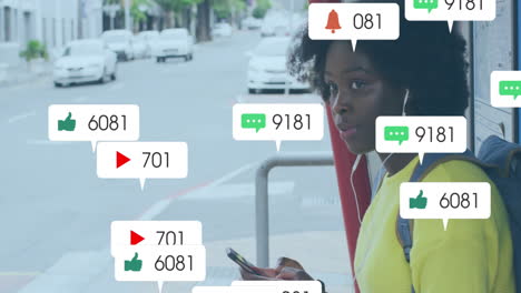 animation of icons and data processing over african american woman using smartphone