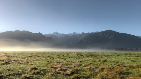 misty sunrise illuminating spectacular scenery with mt cook and mt tasman in background