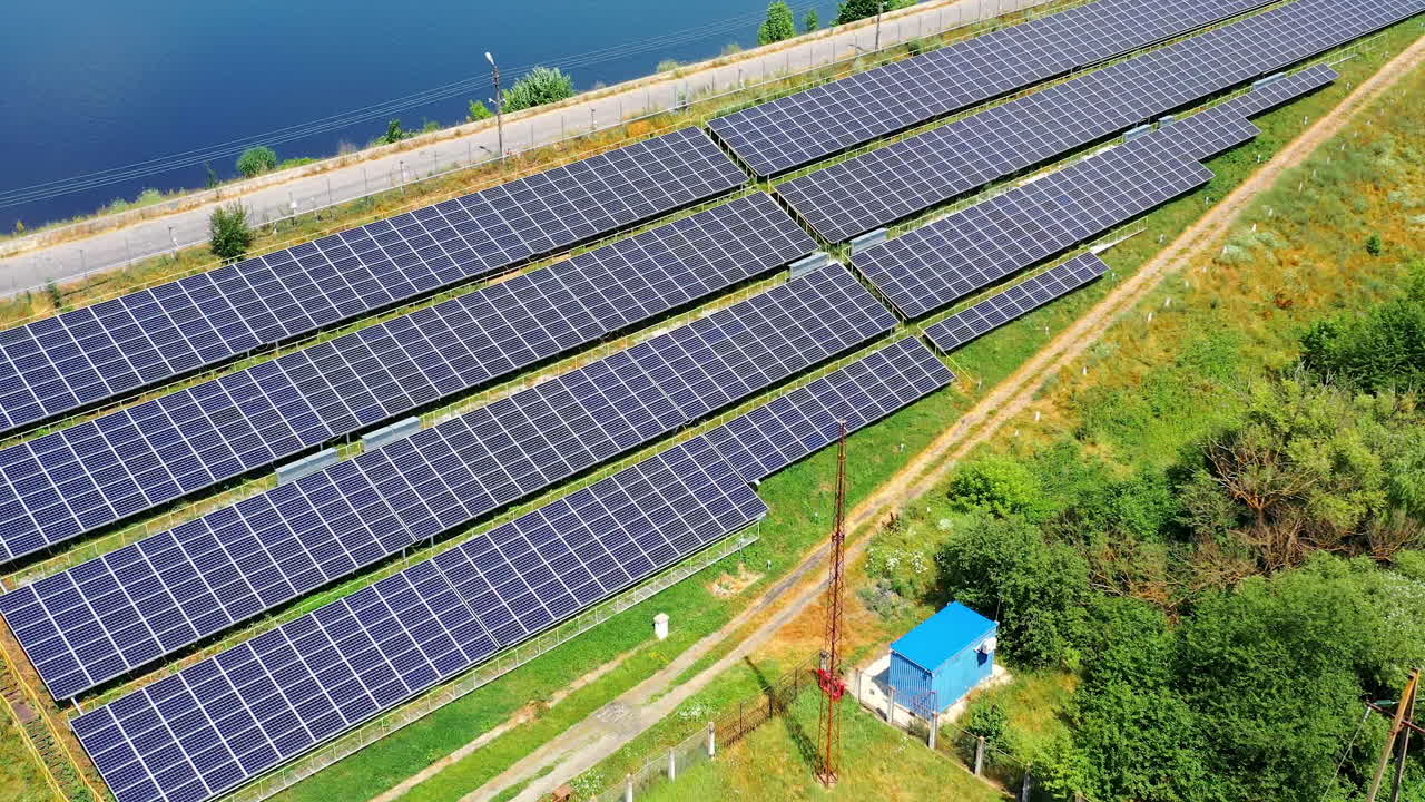 Small solar station in nature. Few sunny batteries getting clean energy from the sun near the sea. Renewable source of energy. Aerial view.