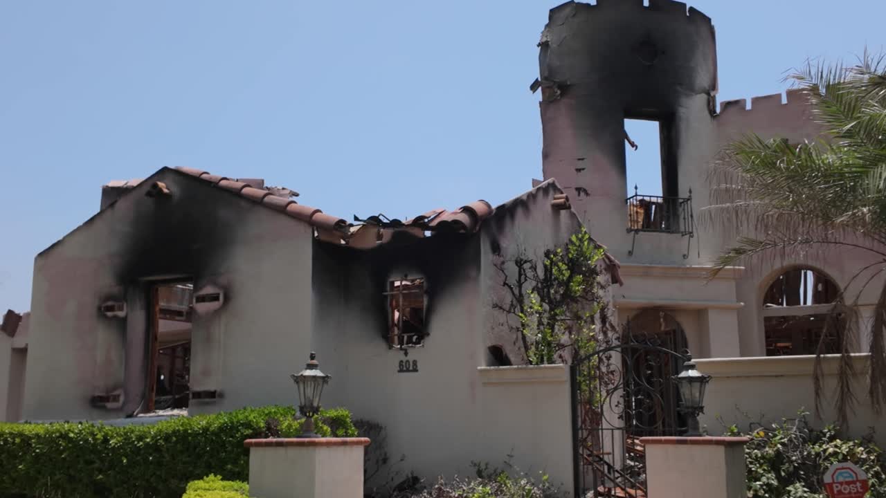 Gimbal close-up panning shot of the charred ruins of a home burned by the Eaton Fire in Altadena, California. 4K