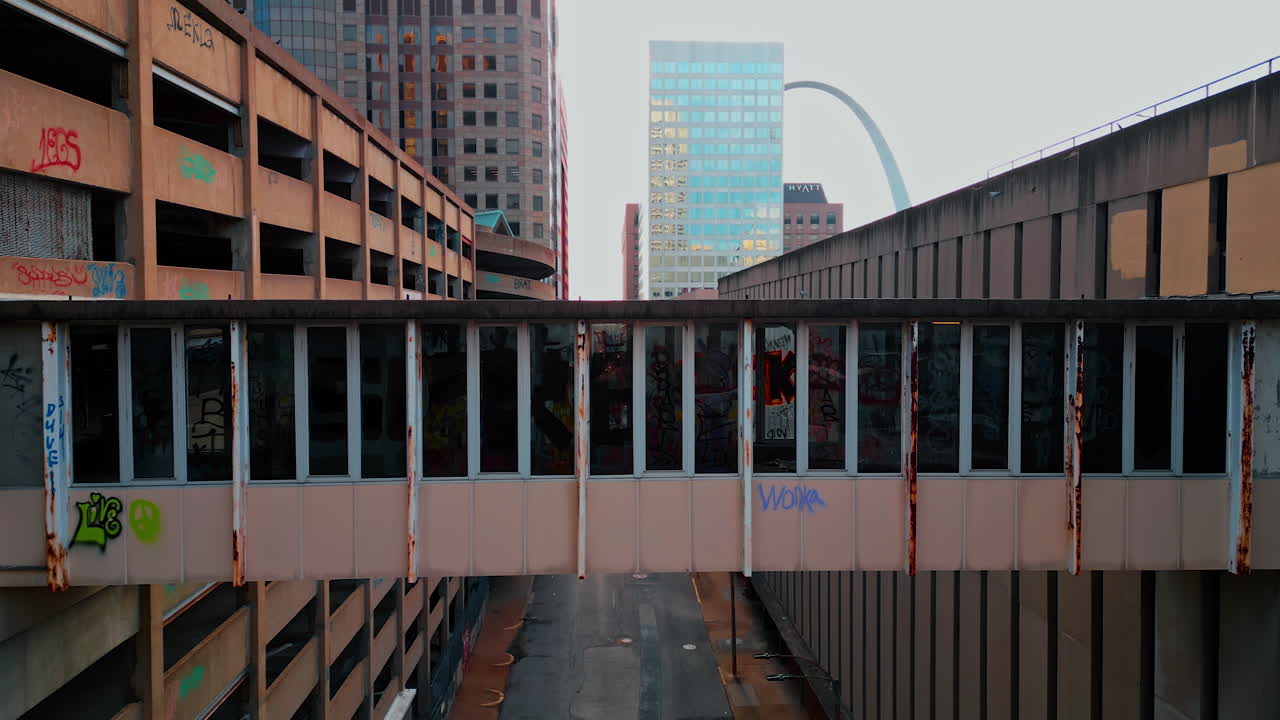 Saint Louis USA, 14 August 2025: Old forlorn building with graffiti, broken windows and rusty elements. Modern high-rises at backdrop. St. Louis, Missouri, USA. Aerial view