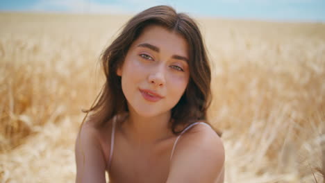 rural portrait beautiful woman in summer rye field. smiling young lady posing