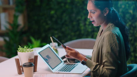 young-indian-business-woman-working-late-colleagues-brainstorming-creative-ideas-discussing-project-deadline-collaborating-planning-successful-strategy-in-trendy-startup-office-workspace