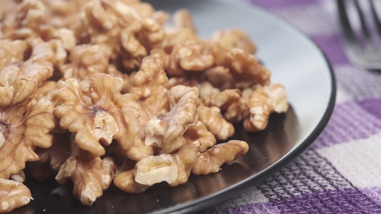 Pile of Walnuts on a Black Plate