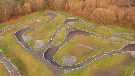 eboarder riding around a bmx pump track