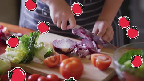 Animation-of-red-tomato-icons-over-caucasian-woman-cutting-vegetables