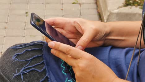 caucasian woman is working on the mobile phone, close up