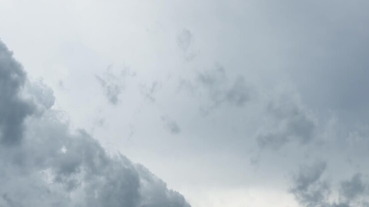 Dark storm clouds rapidly shift across a moody, overcast sky in smooth timelapse motion