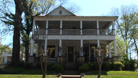 a large secondstory porch dominates the front of this beautiful rural home