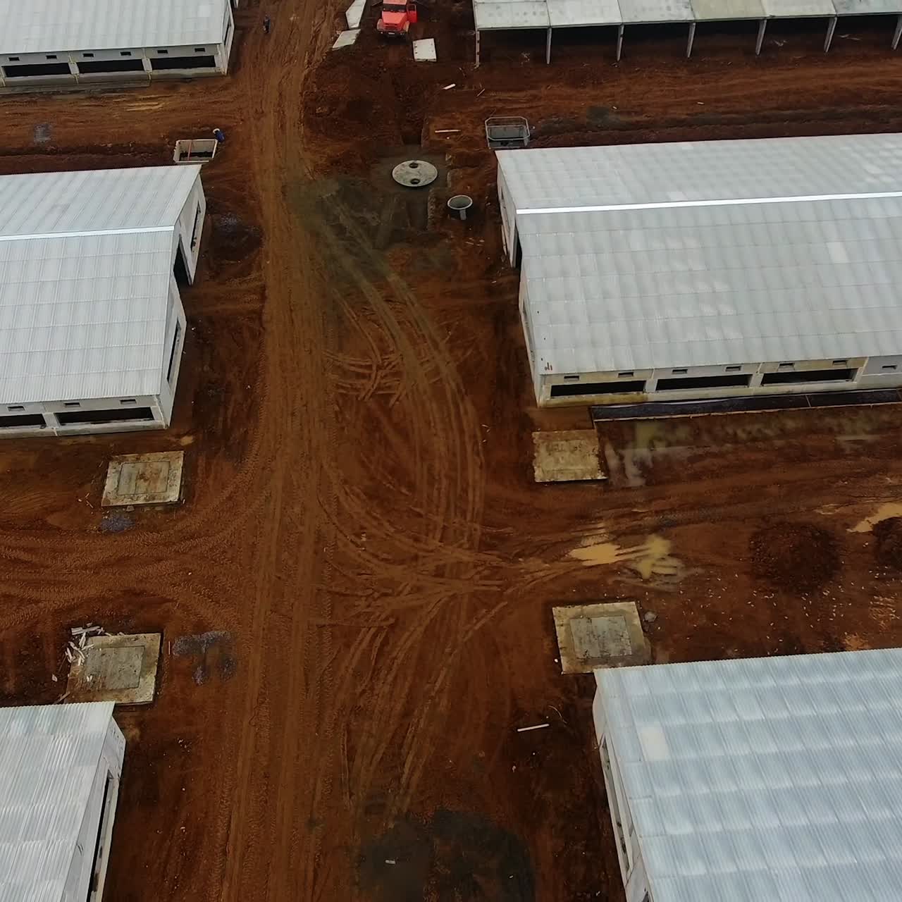 White buildings of new animal farm in the field. View from above on a new industrial complex. Flight over building area. Aerial view