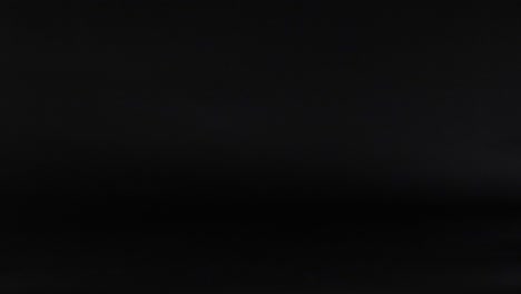 various balls move across a dark background