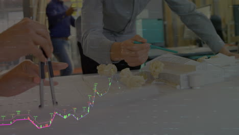 animation of data processing over mid section of team of architects working on a model at office