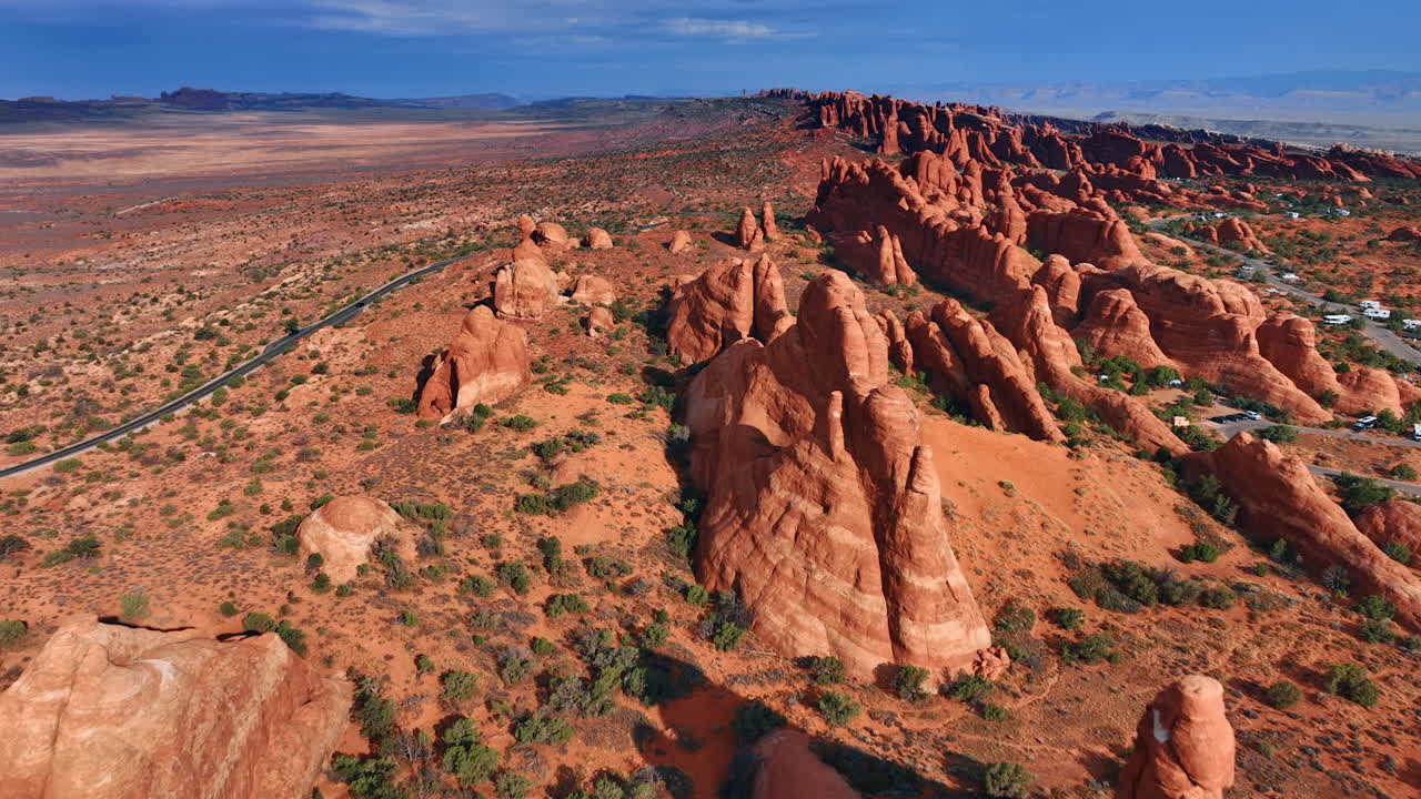 Desert with spectacular canyons lit with bright sun. Drone footage above the Arches National Park, Utah, USA