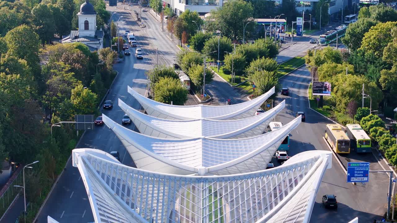 Slow Closeup Drone Shot of Heroes' Gate Monument in Eroii Revolutiei Square with Morning Traffic Below, Bucharest, Romania