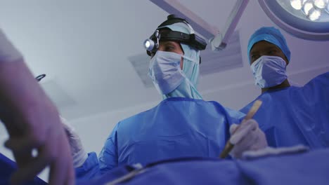 low angle view of middle-east female surgeon performing surgery in operation theater at hospital