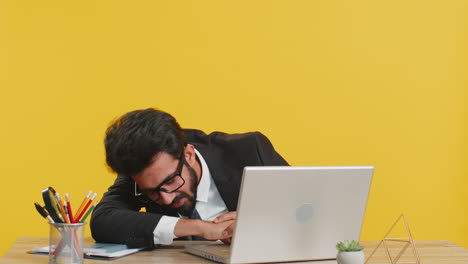 bored sleepy business man worker working on laptop computer yawning falling asleep at home office