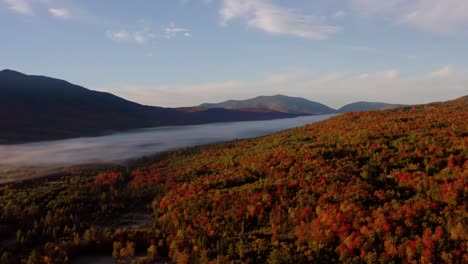 panoramic aerial view of fog streaming across valley in new england at golden hour