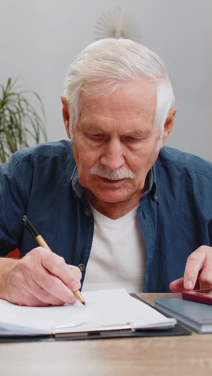 Senior man accounting payments calculating monthly expenses bank bills analyzing paperwork at home
