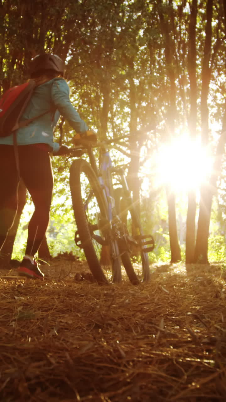 Female mountain running walking with bike
