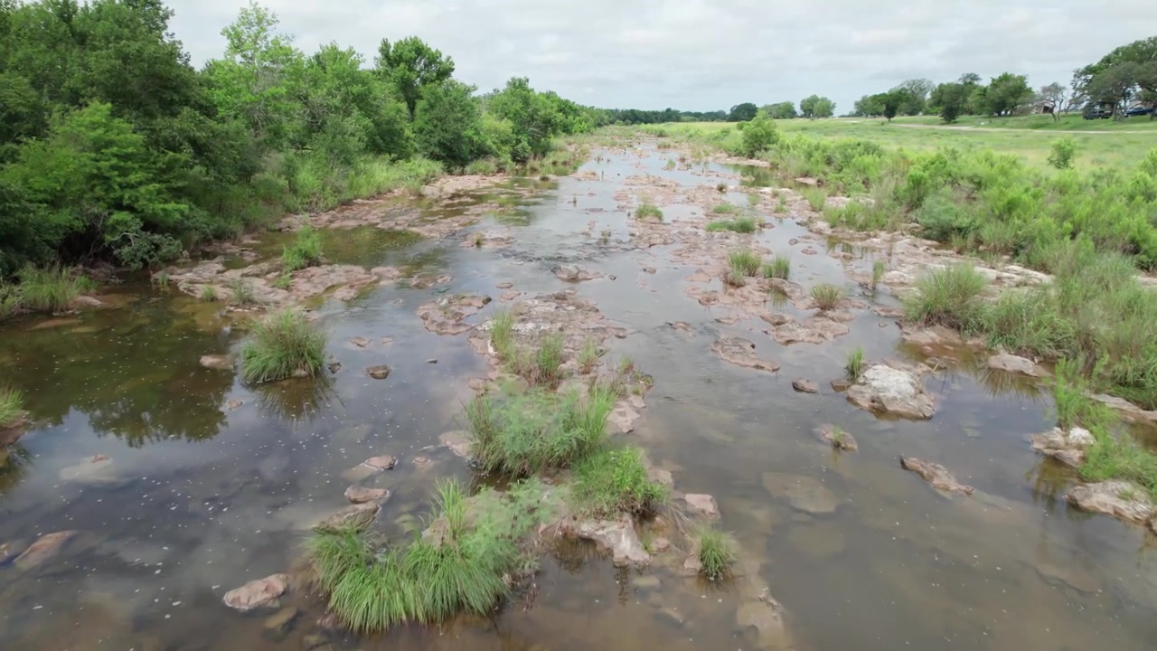 Aerial footage of the Pedernales River in Texas camera flies low and slow over the river