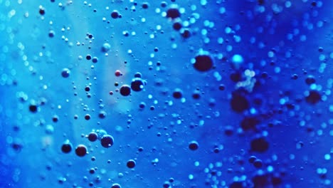 macro shot of little ink bubbles moving in sparkling water