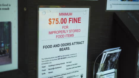 view of penalty fine on a board at the camping ground in glacier national park, montana