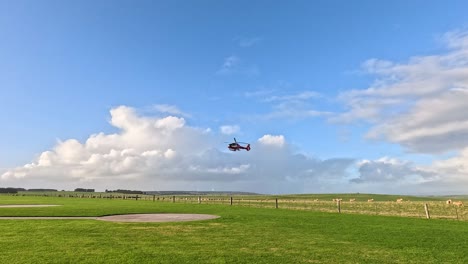 un helicóptero aterrizando en un campo cubierto de hierba
