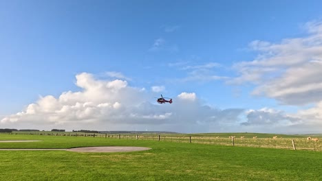 helicopter landing on a grassy field