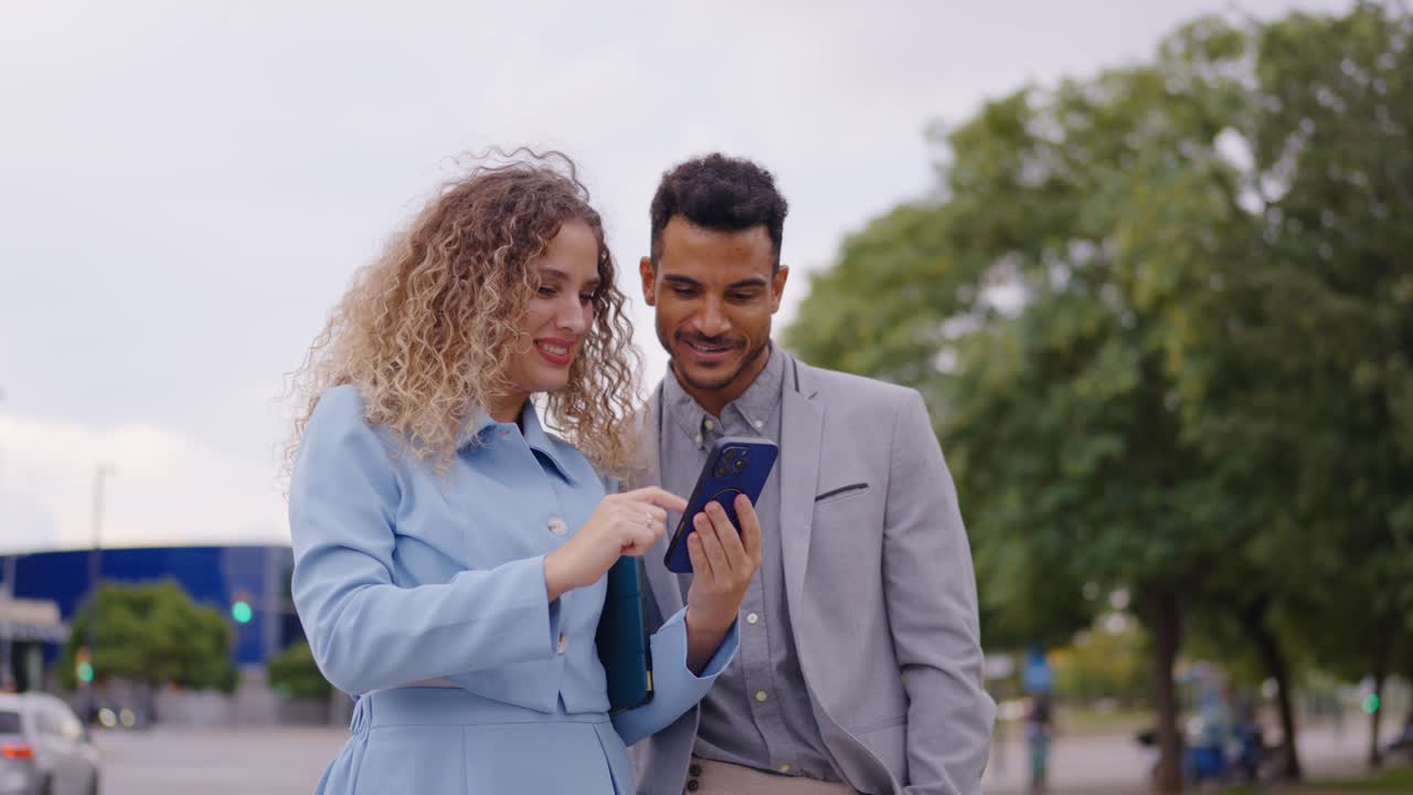 Couple using smartphone outdoors in the city