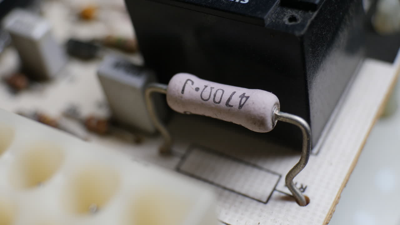Many resistors, capacitors and electronic components on an old retro circuit board controller with other electronics components