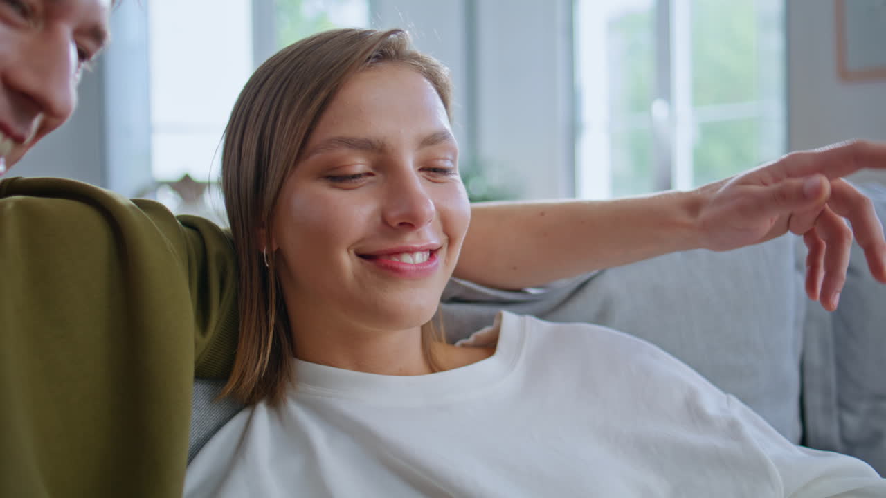 Embracing teenagers talking positively shopping online on tablet at home closeup