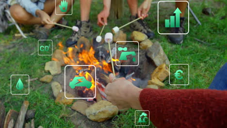 roasting marshmallows over campfire with animation of environmental icons overlay
