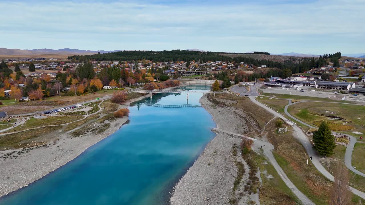 Drone footage captures Lake Tekapo's vibrant autumn colors and serene waters, highlighting the Church of the Good Shepherd