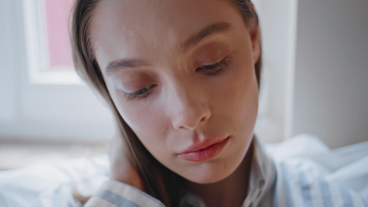 Depressed woman sitting home bed feeling loneliness closeup. Portrait sad girl