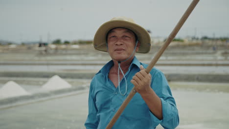 portrait of a salt worker in a salt field