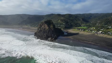 foamy ocean waves at piha beach, north island, new zealand - aerial drone shot