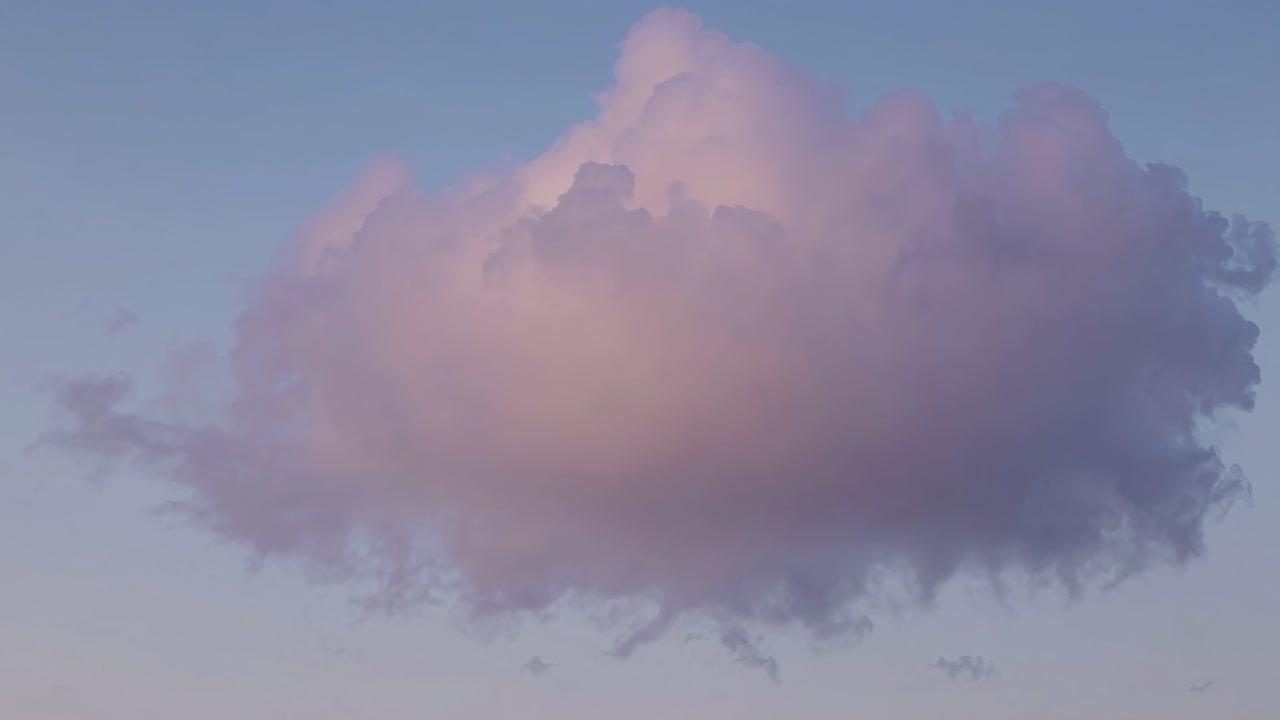A serene video of a single fluffy cloud against a pastel sky, captured from a low angle
