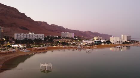 4k aerial drone tracking dolly shot sunset over desert dead sea hotel zone