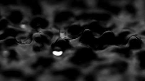 splashes and drops on the surface of the liquid. abstract black background water vibration. 4k slow motion 100 fps, prores 422, 10 bit